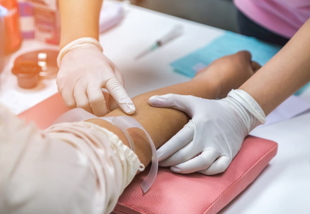 Nurse drawing blood from patient